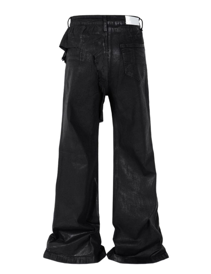 Close-up of waxed black denim fabric showing textured finish and heavyweight material
