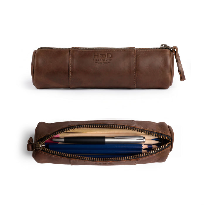 Side view of the Utility Cylinder Case by Hide & Drink showcasing the durable YKK zipper. This handmade and artisan-crafted bag is perfect for organizing personal items and office supplies. Cylinder Case, Classic Bag, Handmade, Rustic, Full Grain Leather.