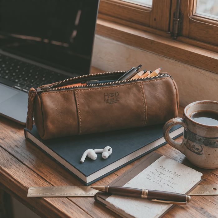 Inside view of the Utility Cylinder Case by Hide & Drink, highlighting its spacious interior for office supplies or cables. This rustic, handmade bag is crafted from Full Grain Leather in La Antigua Guatemala. Cylinder Case, Classic Bag, Small Batch Production, Artisan.