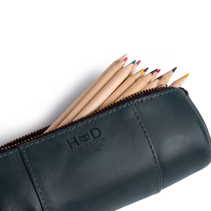 Utility Cylinder Case by Hide & Drink in navy, demonstrating its stylish design and suitable storage for office supplies. This handmade bag emphasizes rustic charm and Full Grain Leather craftsmanship. Cylinder Case, Handmade, Rustic.