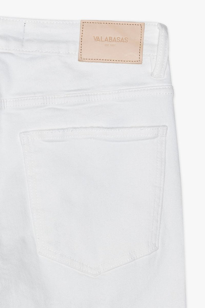Detailed image of the waistband and button closure of Valabasas Mr Stacked white stacked jeans