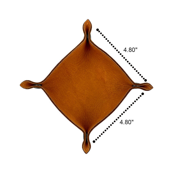 An overhead view of the Valet Tray with Sheep Skin by Hide & Drink, showcasing its unique design and dimensions of 4.80 inches. This artisan-made catchall is crafted from full grain leather and soft sheepskin, perfect for storing personal items like keys and change. Ideal for home and travel, this handmade tray is a blend of style and functionality, featuring small batch production that highlights its handcrafted nature, making it a standout piece for any room.