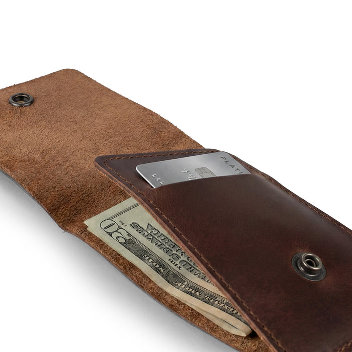 Opened Vertical Wallet by Hide & Drink, ideal for storing cash and cards, this Vertical Front Pocket Wallet with Card Slot ensures compact storage for bills and is designed as a card holder with durable full grain leather. It reflects craftsmanship from small batch production, hand cut, and hand sewn, fire branded by artisans in La Antigua Guatemala & Oaxaca Mexico.