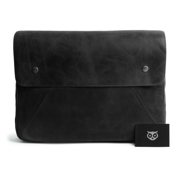 Front view of Hide & Drink's Vintage Folder Holder XL in black leather, showcasing its elegant design and Full Grain Leather texture. A great office accessory, this handmade padfolio is perfect for organizing contracts and documents, created by artisans in La Antigua Guatemala and Oaxaca Mexico.