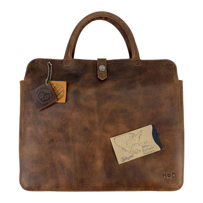 Vintage Portfolio with Snap for 13" MacBook Air by Hide & Drink, featuring a charm and card to emphasize its artisanal background. Made from rich Full Grain Leather through Small Batch Production methods, this Artisan piece showcases hand-cut, hand-sewn, and fire branded details from La Antigua Guatemala & Oaxaca Mexico.