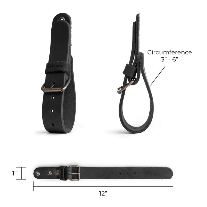 Detailed view of the black Hide & Drink Wall Hanging Strap dimensions, showing its adjustable size and sturdy buckle closure. Ideal for organizing tools and gear, this strap is part of a set of 2 heavy-duty holders suitable for axes, hatchets & tools. Crafted from full grain leather, it emphasizes the artisan craftsmanship through hand-cut and hand-sewn methods from La Antigua Guatemala & Oaxaca Mexico.