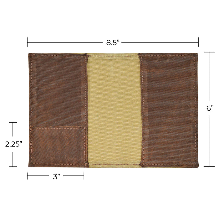 Close up of Hide & Drink Waxed Canvas Field Notes Cover with stickers and tags for added information about the artisan production. The durable design of this Wallet Case (3.5 x 5.5 in.) Journal Cover invites you to jot down thoughts while showcasing premium quality.