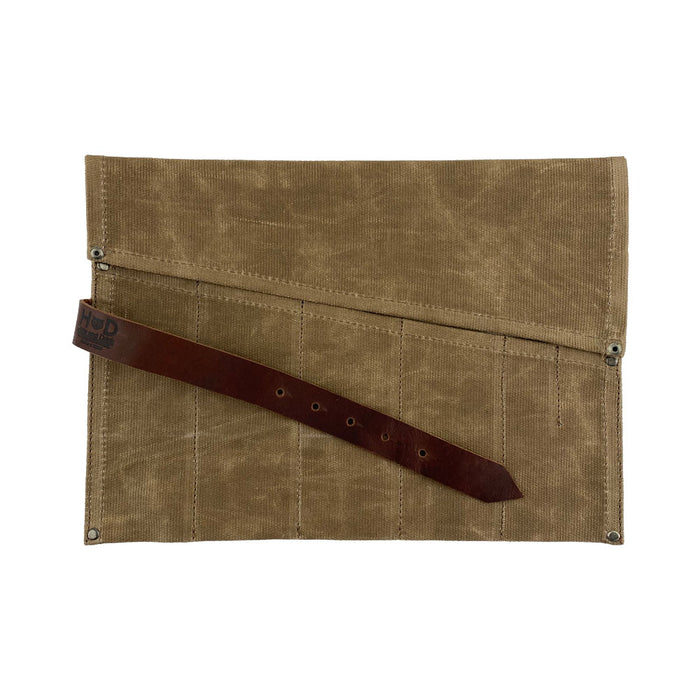 The Large Tool Roll from Hide & Drink showcasing its artisan detail. This Portable Carry-On Pouch provides 6 slots for woodworking tools organization, designed for convenience. Crafted from waxed canvas and full grain leather variations, this artisan item exemplifies hand-cut, hand-sewn craftsmanship made in La Antigua Guatemala & Oaxaca Mexico.