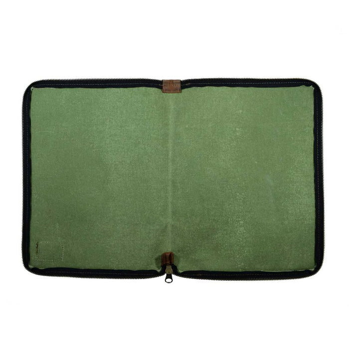 The inside of the Waxed Canvas Zippered Journal Cover for Moleskine (Notebook NOT Included) by Hide & Drink, featuring a soft green lining and a stylish design. Ideal for Cahier Cases, it combines Full Grain Leather craftsmanship with artisan dedication from La Antigua Guatemala & Oaxaca Mexico.