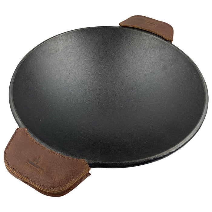 Wok prepared with leather handle covers, the Wok Sidekick from Cast Leather Co. provides both safety and style in the kitchen. These full grain leather handle covers are handmade in La Antigua Guatemala & Oaxaca Mexico, reflecting a rustic charm and artisan craftsmanship.