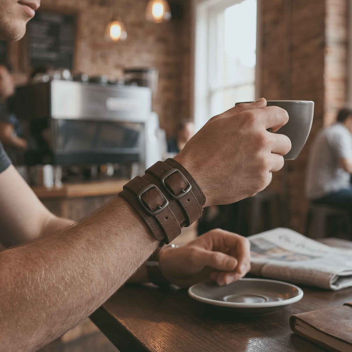 A close-up of Hide & Drink's Wrist-Wallet-Cuff emphasizes its thoughtful design in Full Grain Leather. This rustic leather bracelet is equipped with a hidden pouch for bills and an inner zippered pouch, making it a versatile accessory. Each wallet is handcrafted in La Antigua Guatemala & Oaxaca Mexico, showcasing small batch production and artisan techniques.