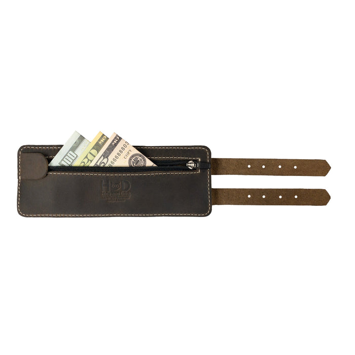 Showcasing Hide & Drink's Wrist-Wallet-Cuff, crafted with care in Full Grain Leather. This rustic leather bracelet features a hidden pouch for bills and an inner zippered pouch, strikingly designed for everyday use. Each piece is artisan-made in La Antigua Guatemala & Oaxaca Mexico, highlighting small batch production.
