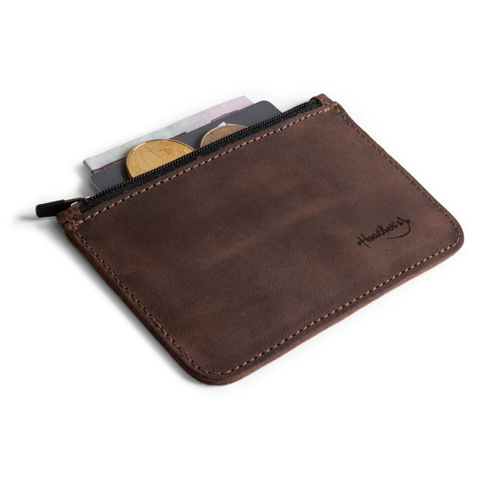 Heather's Zippered Half Wallet open with coins and cash displayed, highlighting its practical design. Made from durable full grain leather, this wallet can hold up to 6 cards, making it an essential travel pouch or money organizer. Crafted artisanally in La Antigua Guatemala with attention to detail.