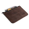 Heather's Zippered Half Wallet open with coins and cash displayed, highlighting its practical design. Made from durable full grain leather, this wallet can hold up to 6 cards, making it an essential travel pouch or money organizer. Crafted artisanally in La Antigua Guatemala with attention to detail.