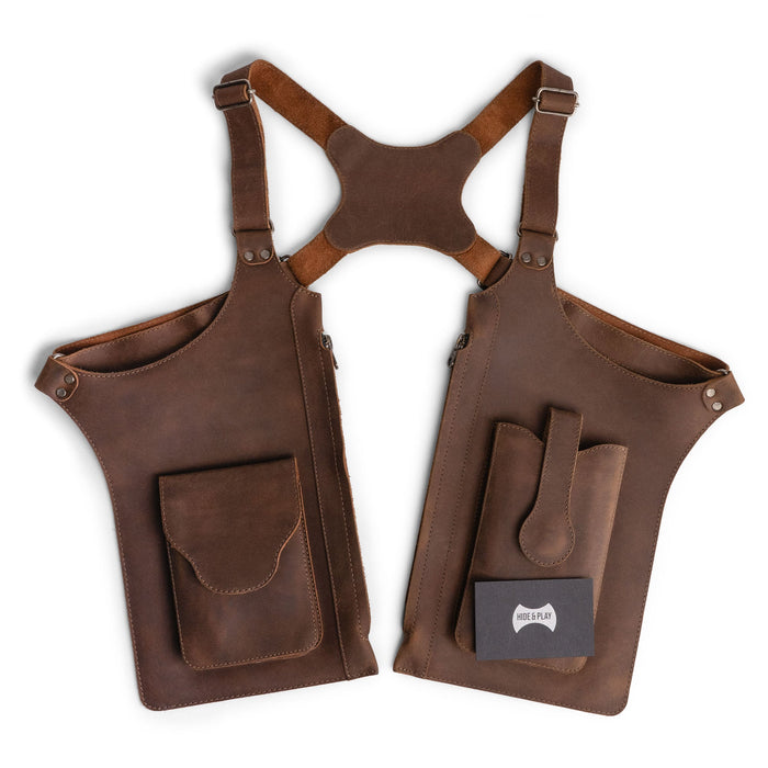 Hide & Play's Zippered Shoulder Holster presented in a polished setting, emphasizing its vintage aesthetic and practical design. An adjustable harness with zippered bags makes it ideal for costume parties, crafted from high-quality full grain leather, embodying artisan workmanship and small batch production in La Antigua Guatemala & Oaxaca Mexico.
